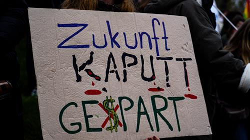 Ein Demonstrationsschild mit der Aufschrift: "Zukunft kaputt gespart", wobei das "s" im Wort gespart als Dollarzeichen abgebildet ist und durchgestrichen wurde!