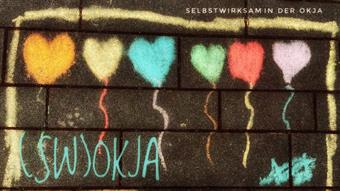 Image of the project with inscription: SWOKJA (Selbstwirksam in der OKJA) coloured chalk on paving stone in the shape of a heart balloon