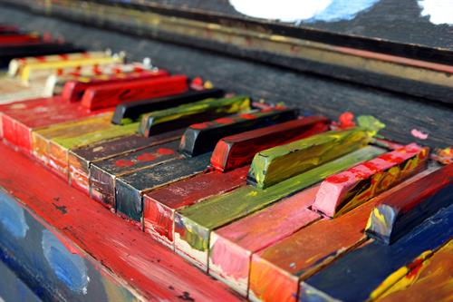 A piano keyboard painted with bright colors.